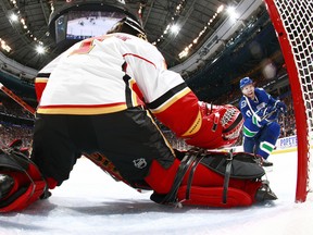 Calgary's Jonas Hiller makes a save on Radim Vrbata of the Canucks during Game 5 on Thursday. (Photo by Jeff Vinnick/NHLI via Getty Images)