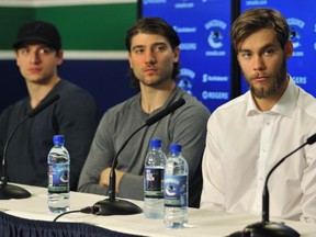 Canucks Luca Sbisa, Chris Tanev and Eddie Lack (left to right) talk to the media at a press conference  in Vancouver  on April 27, 2015.   (Photo by Wayne Leidenfrost/PNG)