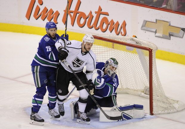 Eddie Lack battles Kyle Cilfford 13,  in Rogers Arena in Vancouver on March 12, 2015  (Mark van Manen/PNG)