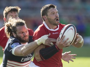 Canada's James Pritchard (right) is tackled by USA's Todd Clever during second half Rugby World Cup Qualifying action in Toronto on Saturday August 24, 2013. THE CANADIAN PRESS/Chris Young