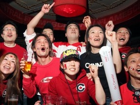 Japanese young people who were working in Calgary on work visas in 2010 react during the gold-medal men’s hockey game between Team Canada and the U.S., which Canada won 3-2 in overtime on Feb. 28, 2010. Former Canadian diplomat Robert Vineberg argues that the federal government should encourage fairness in Canada’s youth work exchange agreements with other countries so more young Canadians can work and travel abroad. The programs, he argues, promote future trade, tourism and investment for Canada.
 — Postmedia News files