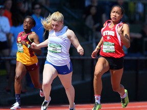 St. Thomas More’s Zion Corrales-Nelson (right) edges Oregon runners Anna Dean (centre) of Hillsboro and Malika Washington of Portland-Central Catholic to win her heat in the 100 metres at Oregon Relays this past weekend at the University of Oregon’s famed Hayward Field. Corrales-Nelson went on to win the 100-, 200- and 400-metre finals. (Photo courtesy Brian Davies, The (Eugene) Register-Guard)