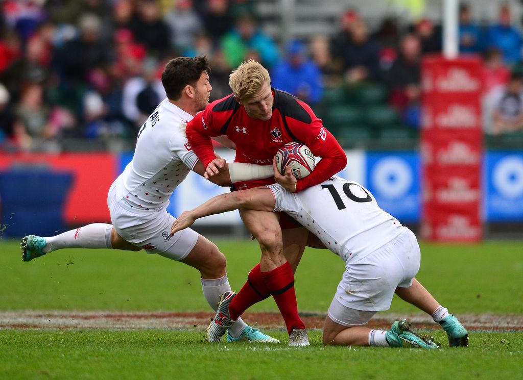 John Moonlight of Canada is tackled by Warwick Lahmert and Jeff Williams of England during the Emirates Airlines Rugby 7s match between Canada and England at Scotstoun Stadium on May 10, 2015 in Glasgow, Scotland. (Photo by Mark Runnacles/Getty Images)