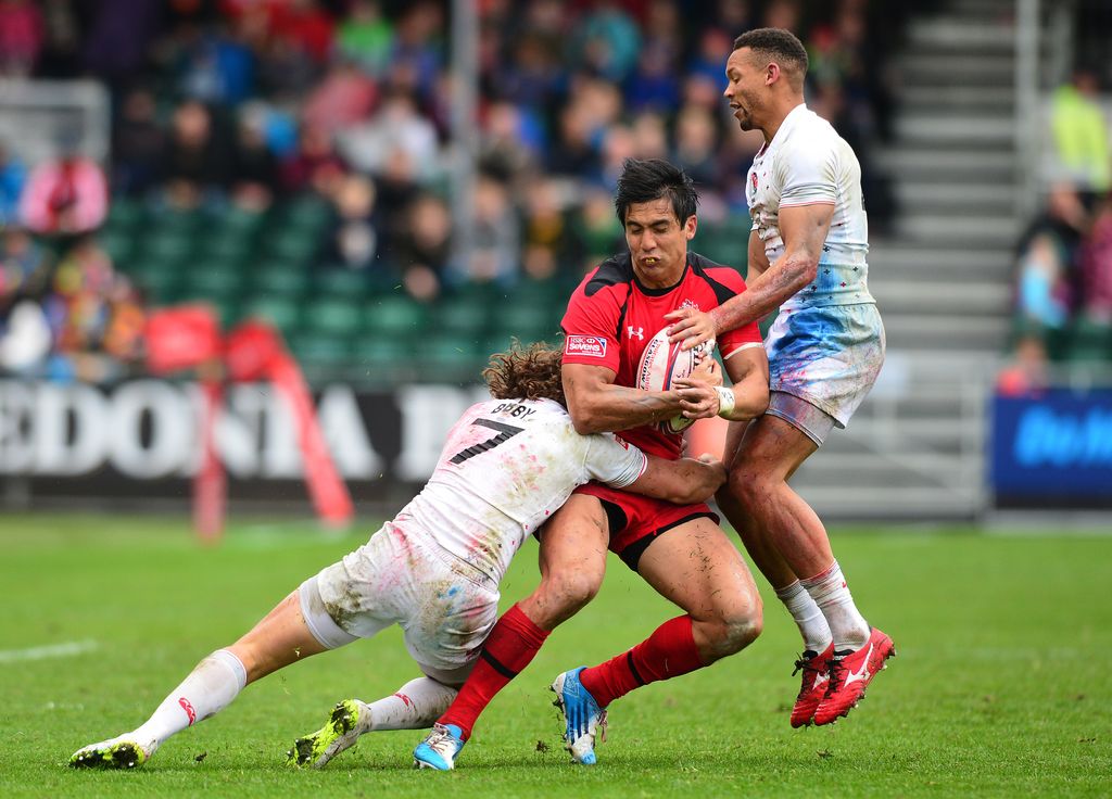Sean Duke of Canada is tackled by Dann Bibby and Dan Norton of England during the Emirates Airlines Rugby 7s match between Canada and England at Scotstoun Stadium on May 10, 2015 in Glasgow, Scotland. (Photo by Mark Runnacles/Getty Images)