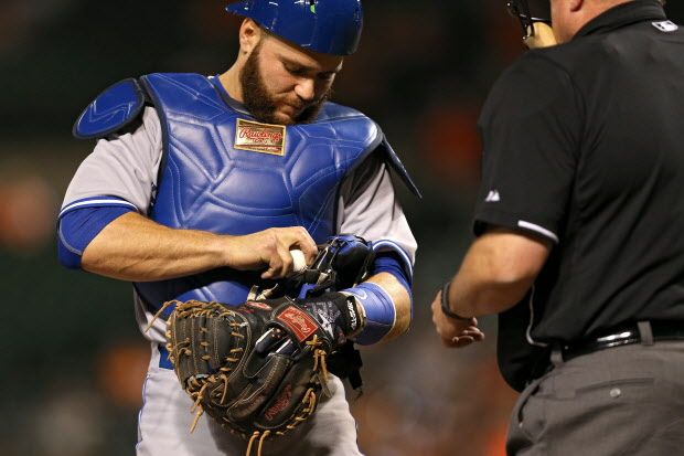 BALTIMORE, MD - MAY 12: Catcher Russell Martin #55 of the Toronto Blue Jays attempts to pull a stuck foul ball in his mask out hit by Steve Pearce #28 of the Baltimore Orioles (not pictured) in the seventh inning at Oriole Park at Camden Yards on May 12, 2015 in Baltimore, Maryland. The Toronto Blue Jays won, 10-2. (Photo by Patrick Smith/Getty Images)