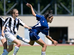 Simran Billen (right) of Surrey’s Fleetwood Park Dragons does her best to elude Leah Favaro of Coquitlam’s Dr. Charles Best Blue Devils during B.C. girls Triple A soccer championship final Saturday at the University of Victoria. (Photo — Darren Stone, Victoria Times-Colonist).