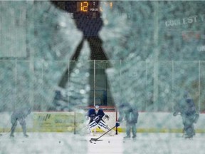 Tampa Bay goalie Ben Bishop is seen practising through a pane of broken glass at the Lightning's practice rink on Monday.