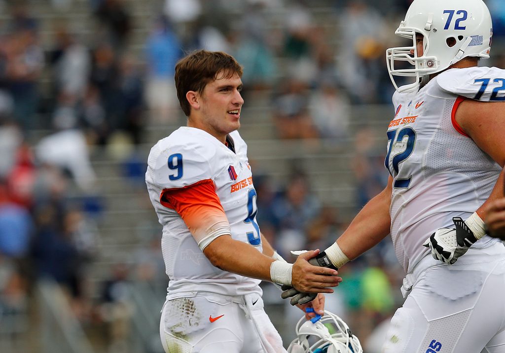 BOSTON, MA - SEPTEMBER 13:   Grant Hedrick #9 of the Boise State Broncos celebrates a touchdown in the second half with offensive linesman Marcus Henry #72  against the Connecticut Huskies at Rentschler Field on September 13, 2014 in East Hartford, Connecticut. (Photo by Jim Rogash/Getty Images)