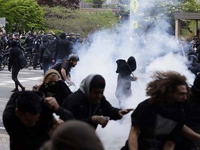 Police and protesters clash during a May Day march Friday, May 1, 2015, in downtown Seattle. (AP Photo/Ted S. Warren)