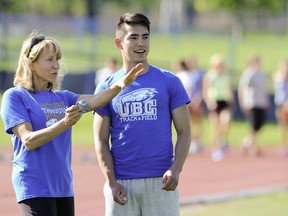 Seaquam Seahawks' Michael Aono receives guidance from his coach with the Vancouver Thunderbirds track club, Mary Chewning, during Monday workout on the Point Grey campus. (PNG photo by Mark van Manen)