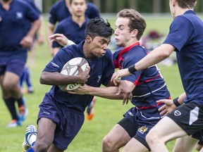 McNair's Pawan Gounden takes it at North Vancouver's Sutherland Sabres in Lower Mainland Tier 2 senior boys rugby final Wednesday at Burnaby Lakes. Sabres won 17-5. (Steve Bosch, PNG)