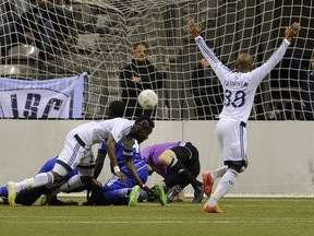 Vancouver Whitecaps celebrate as Gershon Koffie scores late in the game to tie the score 1-1 with FC Edmonton at B.C. Place Stadium in Vancouver on May 13, 2015.  Mark van Manen/PNG