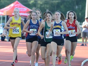 Nicole Hutchinson (second from left) of West Vancouver’s Sentinel Spartans stayed back in the pack but finished strong to win her heat in the senior girls 1,500-metres (4:51.64) Thursday’s at Langley’s McLeod Athletic Park. Salmon Arm’s Glynis Sim (1426, far left) finished second (4:53.27) whole Grace Thompson (second from right) of West Van’s Collingwood Cavaliers was third (4:53.27). (Photo — Howard Tsumura, PNG)