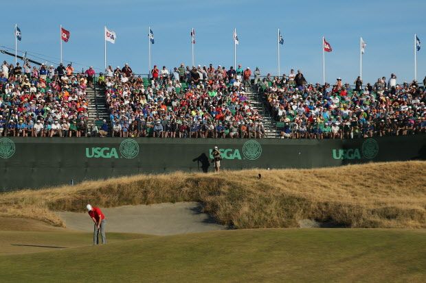 UNIVERSITY PLACE, WA - JUNE 20:  A grandstand of fans watch as Jordan Spieth of the United States putts on the 18th green during the third round of the 115th U.S. Open Championship at Chambers Bay on June 20, 2015 in University Place, Washington.  (Photo by Mike Ehrmann/Getty Images)