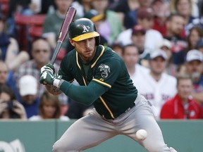 Oakland Athletics' Brett Lawrie takes ball four while pinch-hitting during the eighth inning of a baseball game against the Boston Red Sox in Boston, Saturday, June 6, 2015. (AP Photo/Michael Dwyer)
