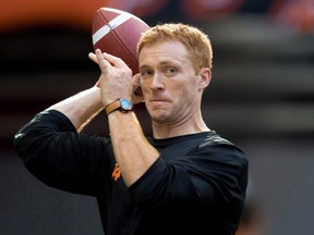 B.C. Lions quarterback Travis Lulay passes as his teammates warm up before a CFL football game against the Winnipeg Blue Bombers in Vancouver, B.C., on Friday July 25, 2014. Lulay drops back to pass and launches a ball down field. At another training camp with another quarterback, the play might be forgotten before the next snap. But as the B.C. Lions gathered for their first practice on Sunday morning, it was a further signal that the club's veteran pivot is ready to put 18 months of shoulder-injury frustration behind him. THE CANADIAN PRESS/Darryl Dyck