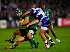 Bath players Max Lahiff (obscured) and Jonathan Joseph combine to thwart Jebb Sinclair of London Irish during the Aviva Premiership match between Bath Rugby and London Irish at the Recreation Ground on April 24, 2015 in Bath, England. (Photo by Stu Forster/Getty Images)