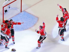 The Chicago Blackhawks converge on goaltender Corey Crawford to celebrate their Stanley Cup win.