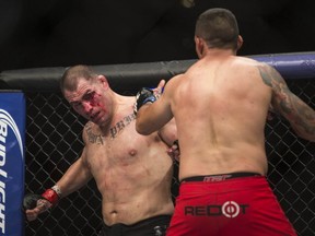 United States´ Cain Velasquez, left, battles against Brazil´s Fabricio Werdum during a men's mixed martial arts UFC 188 heavyweight title fight in Mexico City, Saturday, June  13, 2015. Werdum won the fight by submission. (AP Photo/Christian Palma)