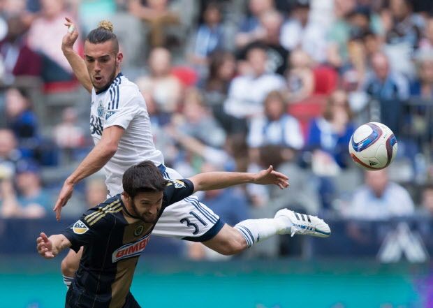 Vancouver Whitecaps' Russell Teibert, back, and Philadelphia Union's Zach Pfeffer vie for the ball during the second half of an MLS soccer game in Vancouver, B.C., on Saturday May 9, 2015. THE CANADIAN PRESS/Darryl Dyck