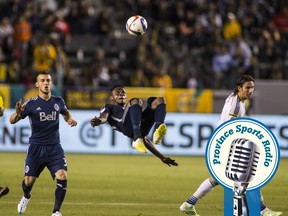 Vancouver Whitecaps midfielder Gershon Koffie, center, goes up for a back kick against Los Angeles Galaxy in the second half of an MLS soccer game at StubHub Center in Carson, Calif., Saturday, June 6, 2015. The Whitecaps won 1-0. (AP Photo/Ringo H.W. Chiu)