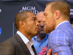 UFC featherweight champion Jose Aldo, left, of Brazil, and challenger (The Notorious) Conor McGregor, right, of Ireland, face off as UFC President Dana White looks on at the UFC 189 World Championship Tour in Toronto on Friday, March 27, 2015. The two meet for real July 11 in Las Vegas. THE CANADIAN PRESS/Neil Davidson