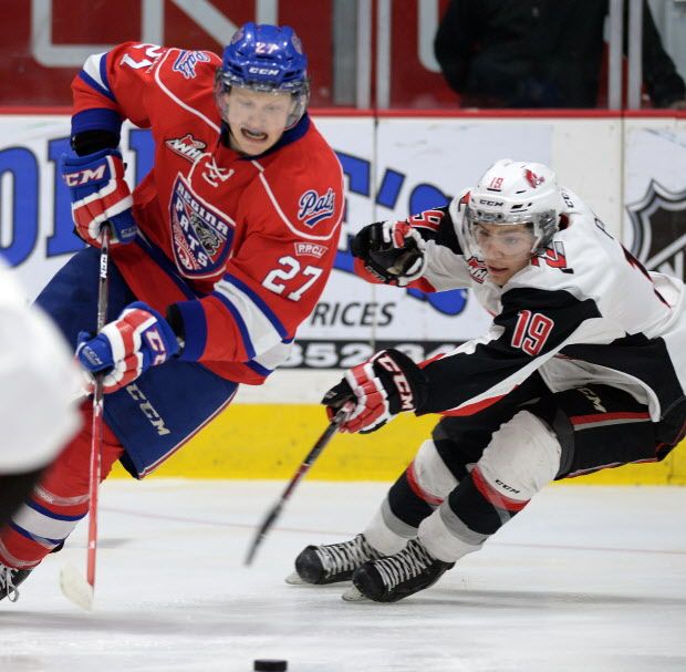 REGINA, SK: JANUARY 23, 2015 - - Regina Pats Austin Wagner (L) is under pressure from Brayden Point (R) with the Moose Jaw Warriors during WHL hockey action at the Brandt Centre in Regina on January 23, 2015. (DON HEALY/Leader-Post) (Story by Greg Harder) (SPORTS)