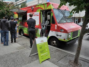 The  Guanaco Salvadoran Cuisine food truck serves lunch on 8th Avenue  in Vancouver on June 18, 2015. (Wayne Leidenfros, PNG)