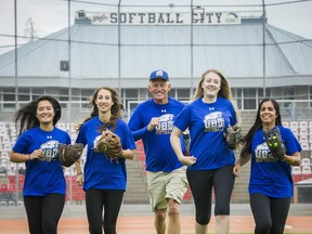 UBC head softball coach Gord Collings with veteran players (left to right) Marga Sison, Shayla Kaplen, Lindsey Ogilvie and Quinn Dhaliwal at the team's new home park, Surrey's Softball City. (Ric Ernst, PNG photo)