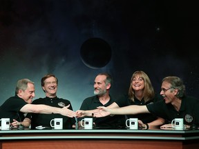 Principal investigator Alan Stern, project scientist Hal Weaver, investigator Will Grundy, project scientist Cathy Olkin and imaging team leader John Spencer celebrate after seeing images from the New Horizons spacecraft that passed with 7,800 miles of Pluto yesterday, during a NASA news conference July 15, 2015 in Laurel, Maryland. Images from the flyby are being released as they become available. The 1,050-pound piano sized probe, which was launched January 19, 2006 aboard an Atlas V rocket from Cape Canaveral, Florida, zipped by the planet last week.  (Photo by Mark Wilson/Getty Images)