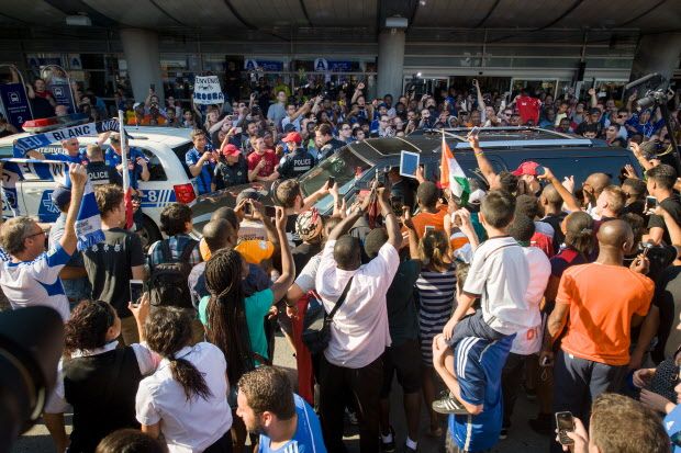 Fans of Didier Drogba surround his car as police try to hold clear a path at Pierre Trudeau Airport in Montreal, Quebec, on July 29, 2015. Drogba arrived from London England Wednesday afternoon and was greeted by hundreds of chanting fans. (Frederic Hore / MONTREAL GAZETTE)