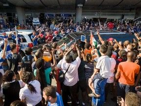 Fans of Didier Drogba surround his car as police try to hold clear a path at Pierre Trudeau Airport in Montreal, Quebec, on July 29, 2015. Drogba arrived from London England Wednesday afternoon and was greeted by hundreds of chanting fans. (Frederic Hore / MONTREAL GAZETTE)