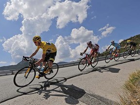 The man in the yellow jersey, Chris Froome, leads the peleton on a descent during Wednesday's 17th stage of the Tour de France.