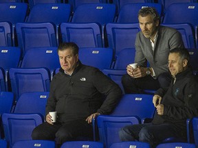 Former Canucks assistant GM Laurence Gilman (right), watches practice with GM Jim Benning and Trevor Linden.