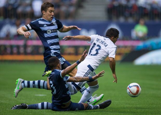 Vancouver Whitecaps' Cristian Techara, right, of Uruguay, tries to break through Sporting Kansas City's Matt Besler, back left, and Amadou Dia during the first half of an MLS soccer game in Vancouver, B.C., on Sunday July 12, 2015. THE CANADIAN PRESS/Darryl Dyck
