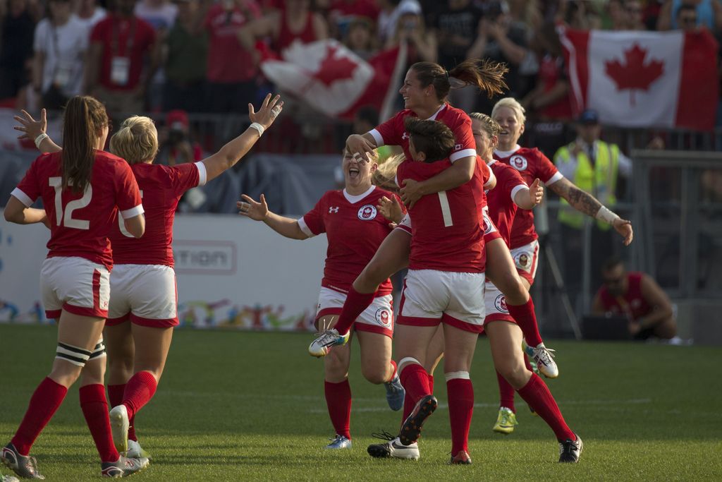 Canadian players celebrate at the final whistle as they win the gold medal in women's rugby sevens after beating the USA 55-7 in the final at the 2015 Pan Am games in Toronto on Sunday, July 12, 2015. THE CANADIAN PRESS/Chris Young