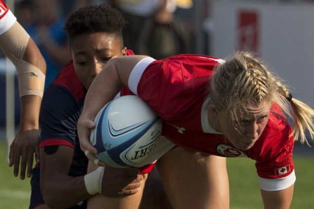 Canada's Kayla Moleschi (right) drives through a tackle from USA's Kristen Thomas during women's rugby sevens gold medal game at the 2015 Pan Am games in Toronto on Sunday, July 12, 2015. Canada secured the gold medal with a 55-7 win. THE CANADIAN PRESS/Chris Young