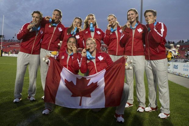 Canada's women's rugby sevens team pose with their gold medals after beating USA 55-7 at the Pan Am Games in Toronto on Sunday, July 12, 2015. THE CANADIAN PRESS/Chris Young