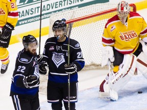 Taylor Crunk (No. 22) of the Victoria Royals celebrates his goal against goaltender Payton Lee of the Vancouver Giants with teammate Logan Fisher during the third period of their WHL game at the Pacific Coliseum on November 15, 2014 in Vancouver, British Columbia, Canada. (Photo by Ben Nelms/Getty Images)