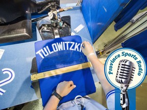 The Blue Jays shop employee Nico Canavo makes a Troy Tulowitzki jersey in Toronto, Tuesday July 28, 2015. The Blue Jays acquired Tulowitzki and reliever LaTroy Hawkins from the Colorado Rockies in a trade involving Jose Reyes. THE CANADIAN PRESS/Mark Blinch
