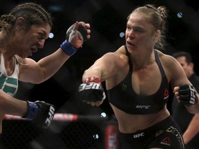 Ronda Rousey (R) of U.S fights with Bethe Correia of Brazil during their Ultimate Fighting Championship match, a professional mixed martial arts competition in Rio de Janeiro, Brazil August 1, 2015. REUTERS/Ricardo Moraes