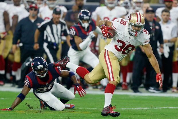 Jarryd Hayne breaks the tackle attempt of Rahim Moore(Photo by Bob Levey/Getty Images)