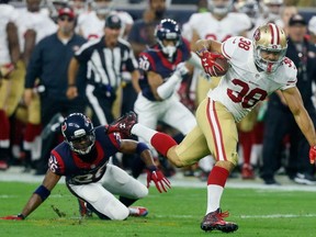 HOUSTON, TX - AUGUST 15:  Jarryd Hayne #38 of the San Francisco 49ers breaks the tackle attempt of Rahim Moore #26 of the Houston Texans in the first half at Reliant Arena at Reliant Park on August 15, 2015 in Houston, Texas.  (Photo by Bob Levey/Getty Images)