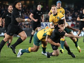 All Black Nehe Milner-Skudder (R) of New Zealand is tackled by Nic White (C) and Israel Folau (L) of Australia during the Bledisloe Cup rugby union match between the Australian Wallabies and New Zealand All Blacks in Auckland on August 15, 2015. Fiona GOODALL/AFP/Getty Images