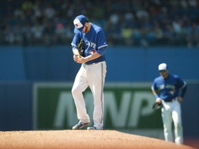 Toronto Blue Jays starting pitcher Drew Hutchison pauses on the mound before throwing against the New York Yankees during sixth inning American League MLB baseball action in Toronto on August 16, 2015. The Blue Jays have sent right-hander Drew Hutchison to triple-A Buffalo a day after he pitched Toronto to a win over the rival New York Yankees. THE CANADIAN PRESS/Fred Thornhill