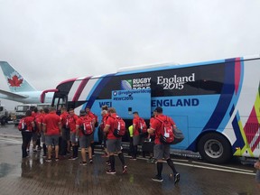 Canada boarding their coach in soggy England.