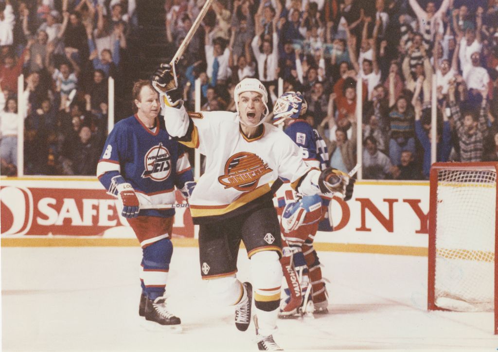 March 1991. Geoff Courtnall celebrates after scoring in overtime against the Winnipeg Jets.  Nick Didlick/PNG