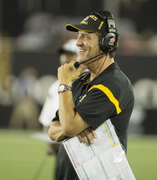 Hamilton Tiger-Cats head coach Kent Austin smiles after a play in the second half of CFL football action against the B.C. Lions in Hamilton on Saturday, August 15, 2015. The Tiger-Cats defeated the Lions 52-22. THE CANADIAN PRESS/Peter Power