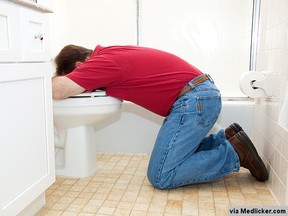hangover-man-vomitting-in-toilet-bowl-454041d841