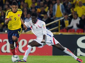 Jordan Smith, in white, takes on Colombia's Luis Muriel during the 2011 FIFA Under-20 World Cup in Bogota.